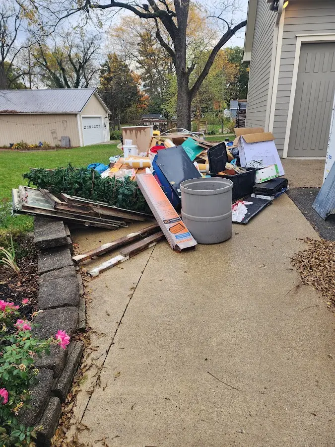 Dumpster being loaded with debris for 12 Yard Dumpster Rental in West Modesto
